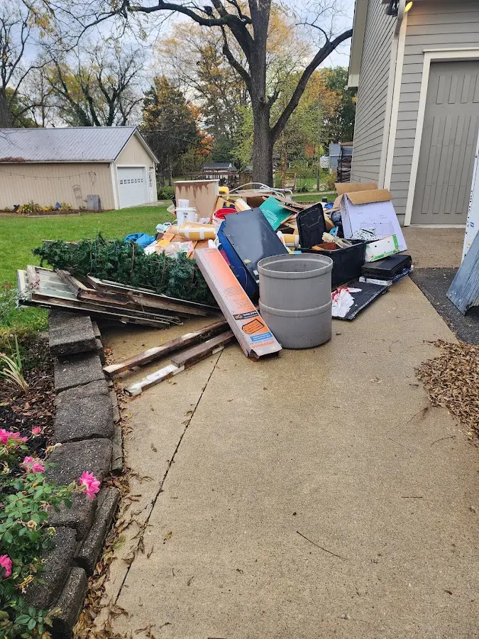 Dumpster being loaded with debris for 12 Yard Dumpster Rental in Zachary